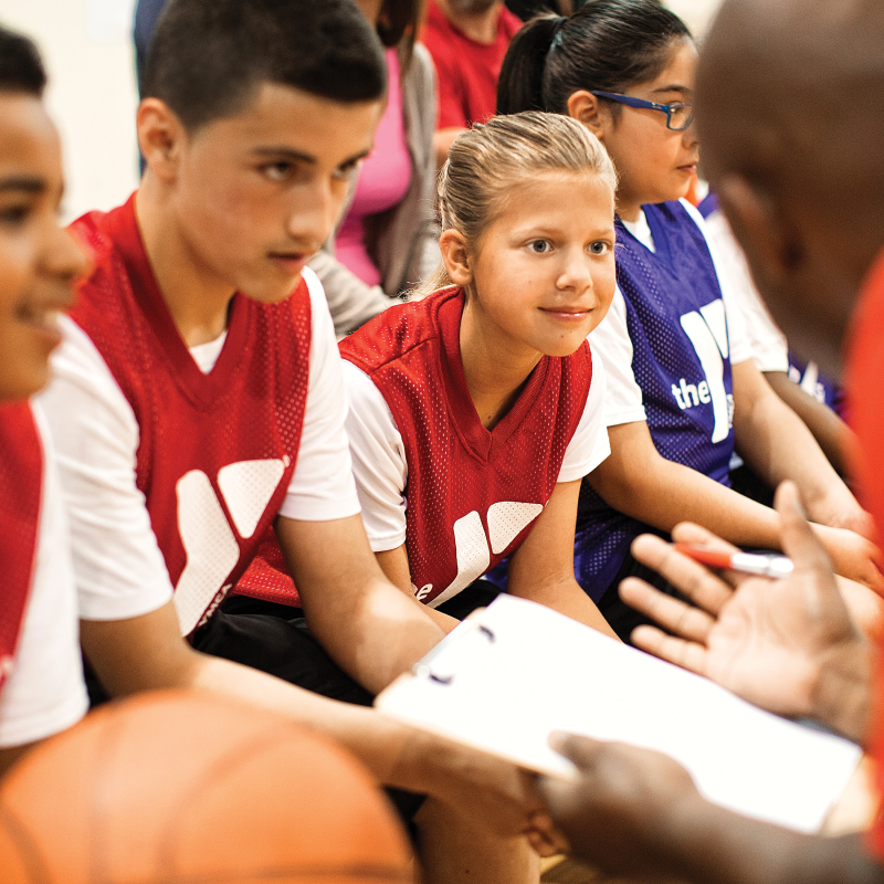 Player focused to their coach going over the game plan