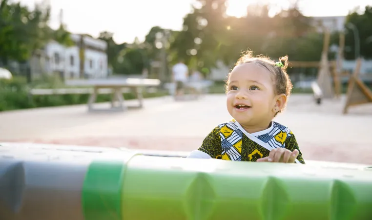 A youth enjoying the outside playground.