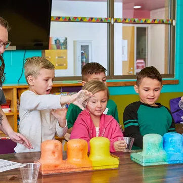 YMCA staff and kids doing a science experiment