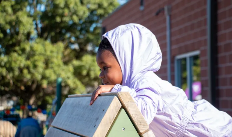preschool student explores the Hilltop YMCA's Nature Playscape for the first time