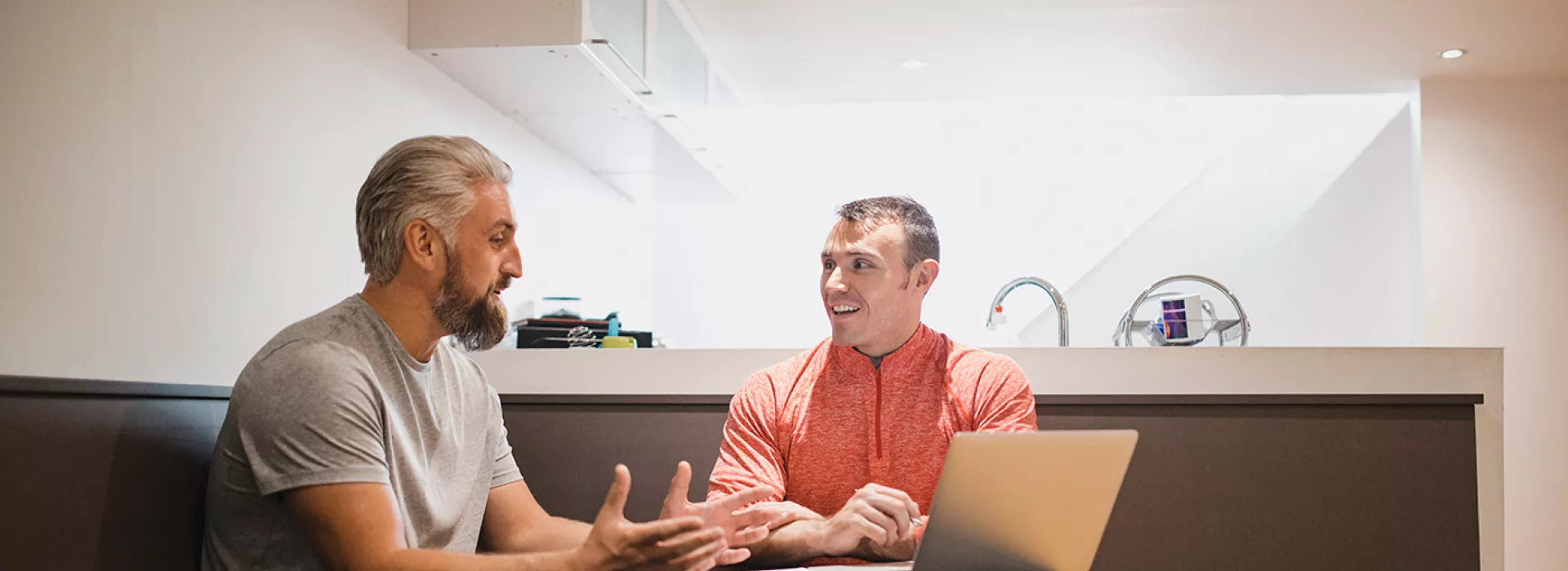 Two men sitting indoors having a discussion