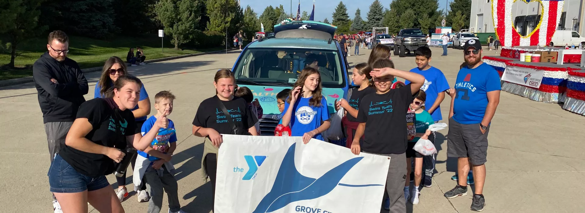 Kids holding a banner that reads Grove City Manta Rays
