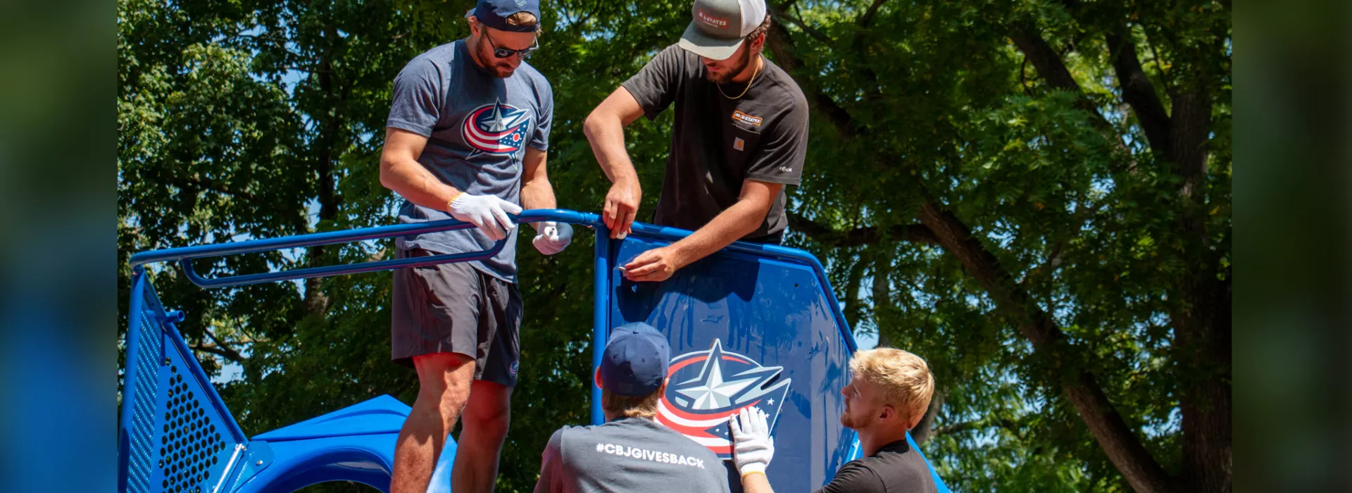 Volunteers working on playground equipment