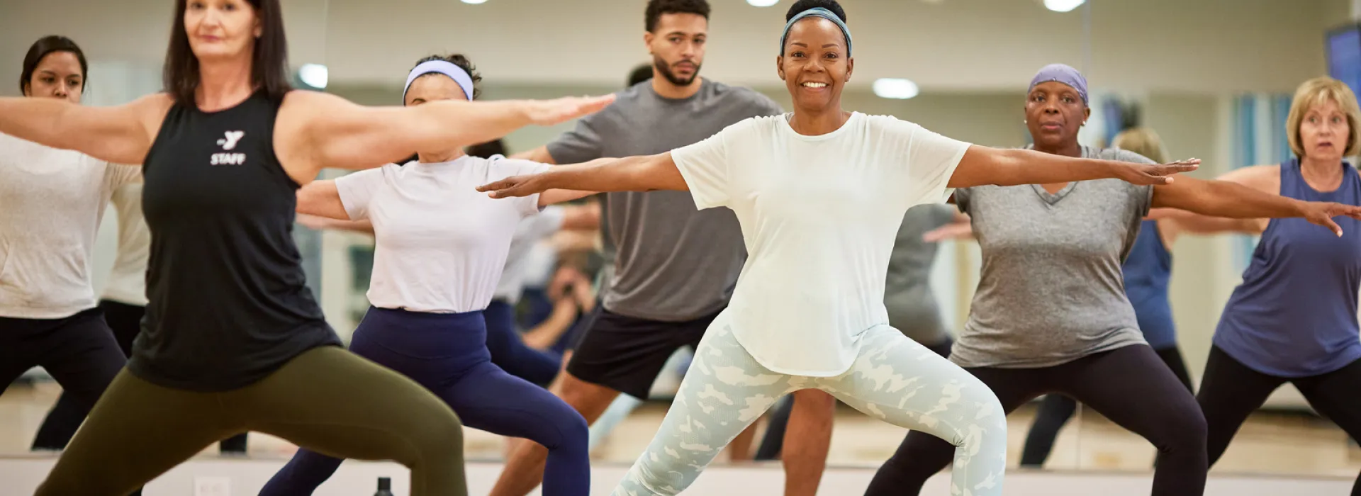 A group of adults in a YMCA class in a studio