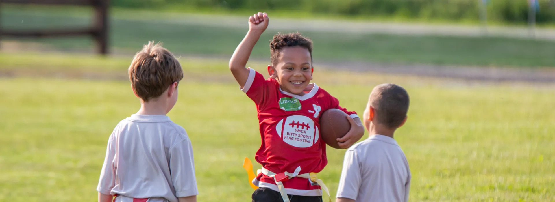 Three youth celebrating at a Bitty Sports Flag Football Game