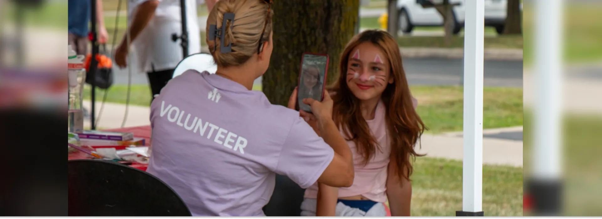 Grove City Family Fun - girl getting her face painted by a volunteer
