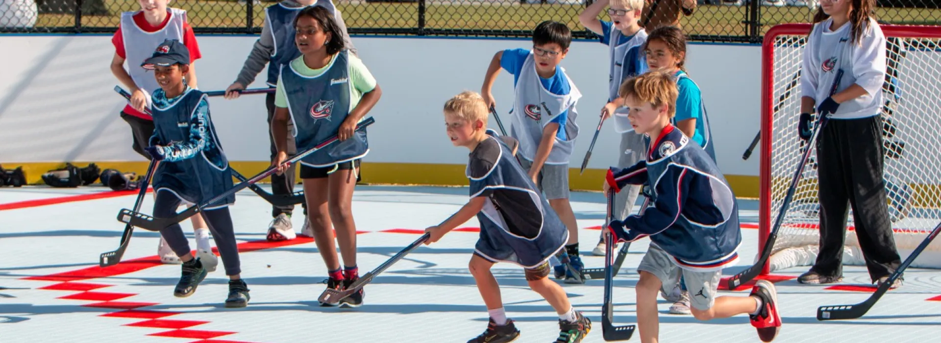 young athletes participate in hockey clinic with CBJ on brand new Liberty Township/Powell YMCA outdoor street hockey rink